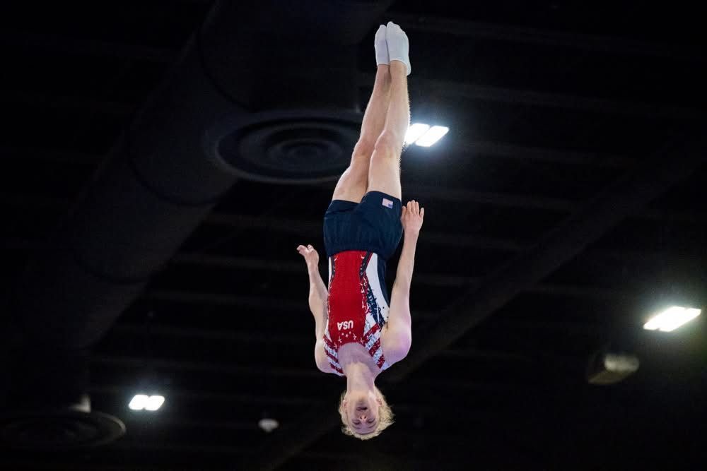 A group of female gymnasts are giving each other a high five.