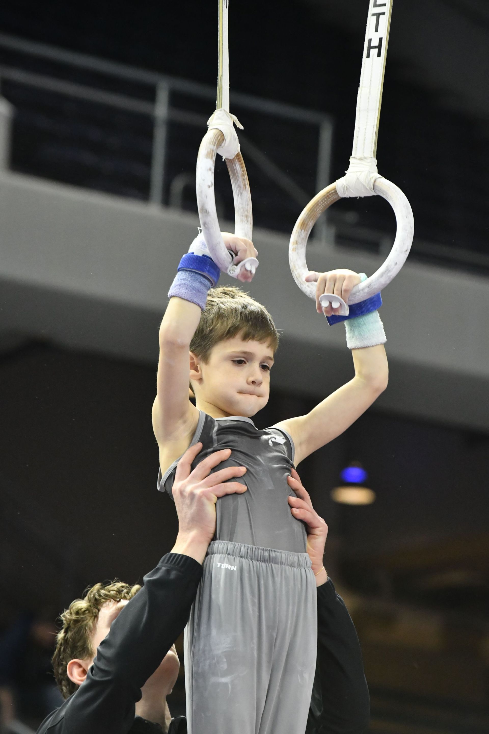 A man and a woman are standing next to each other on a balance beam.
