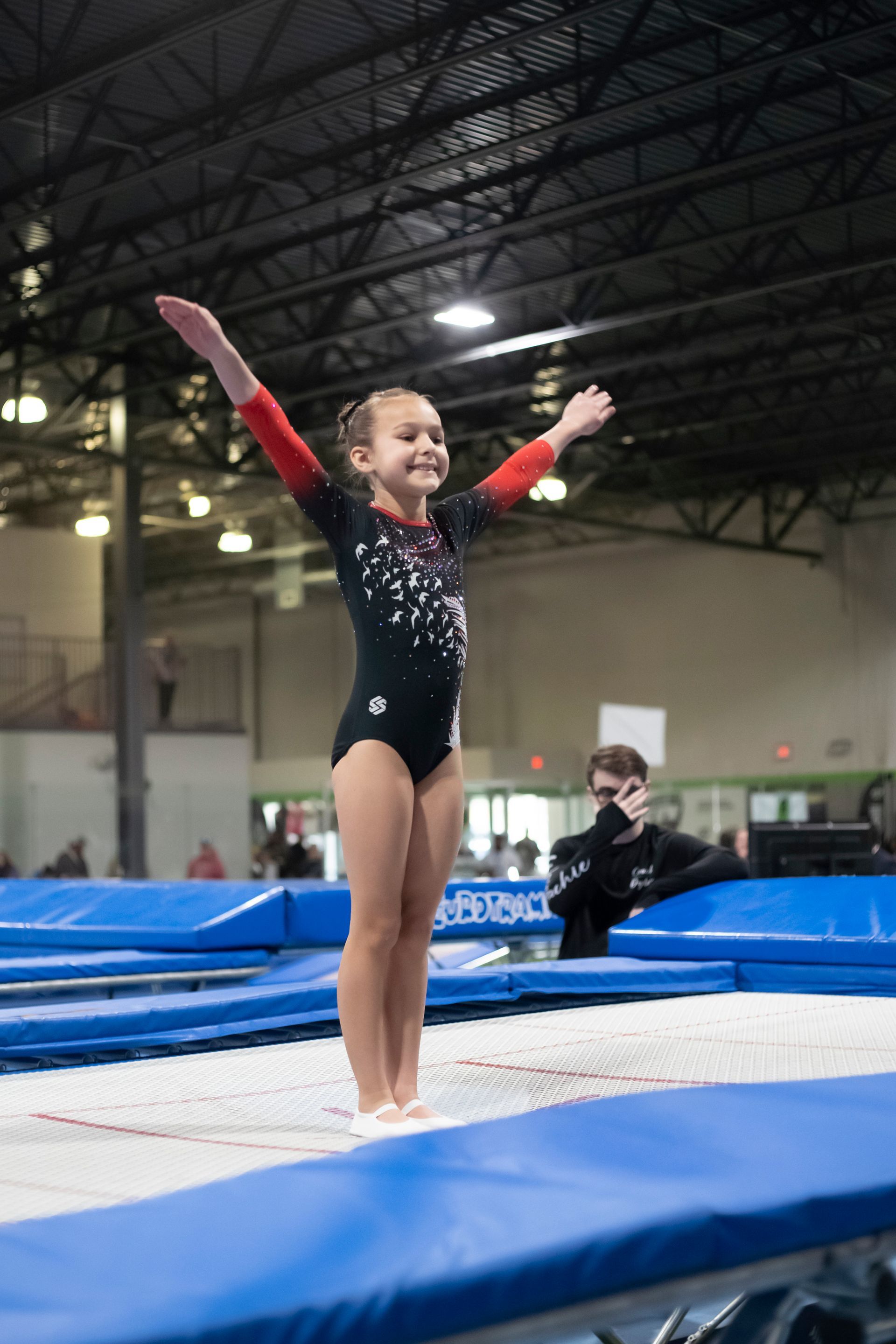 A woman is doing a handstand in front of a ford logo
