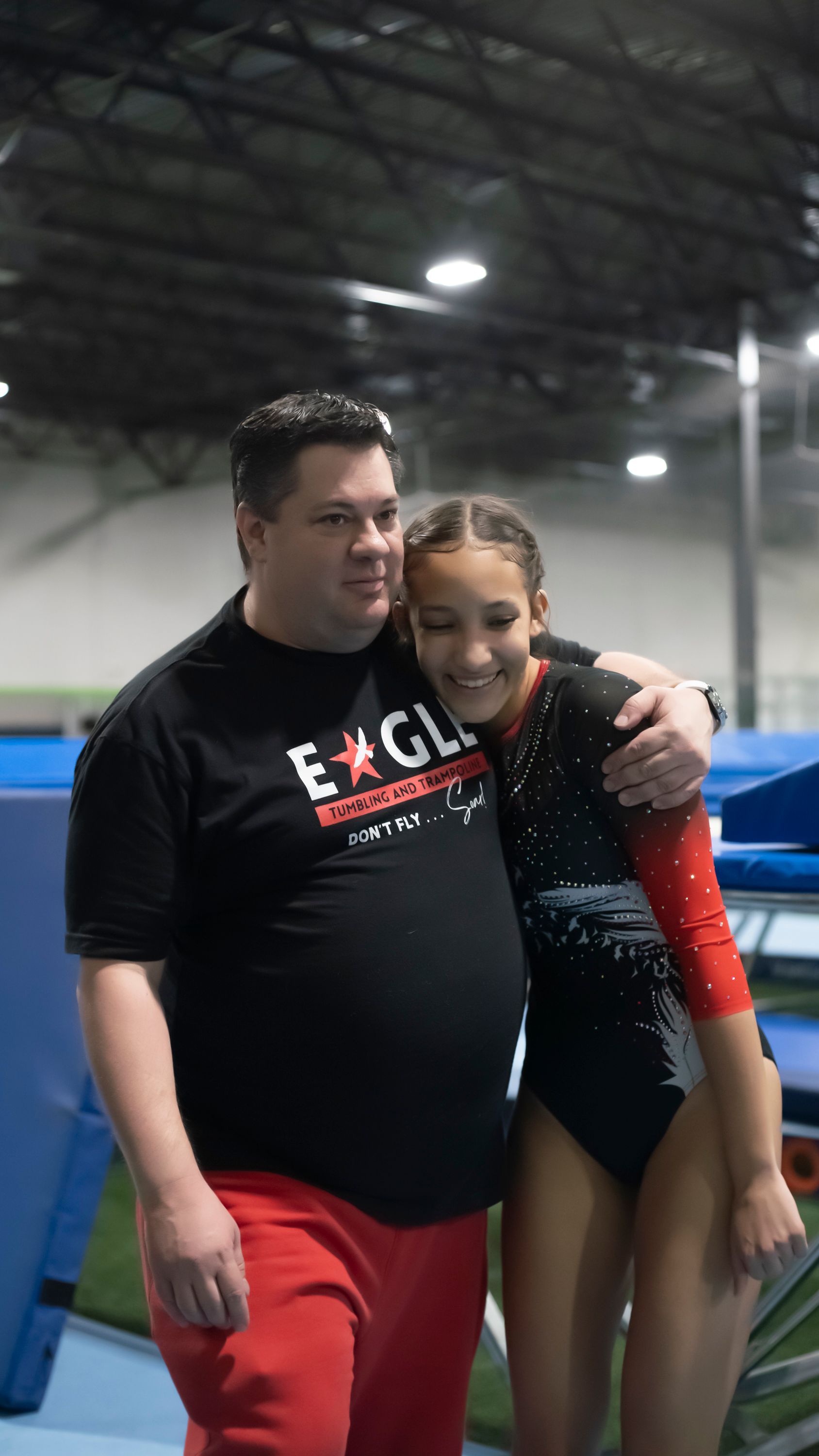 A young boy is doing a handstand on a trampoline.