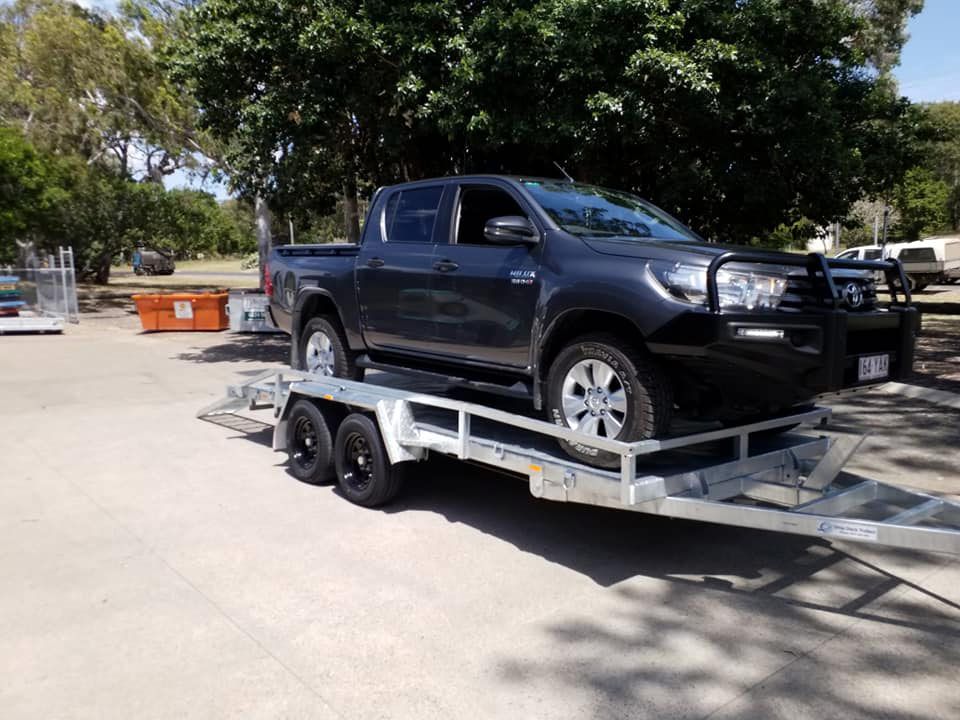 Black Toyota Hilux Loading On The Heavy Duty Car Carrier Trailer — Drop Deck Trailers In Maryborough QLD