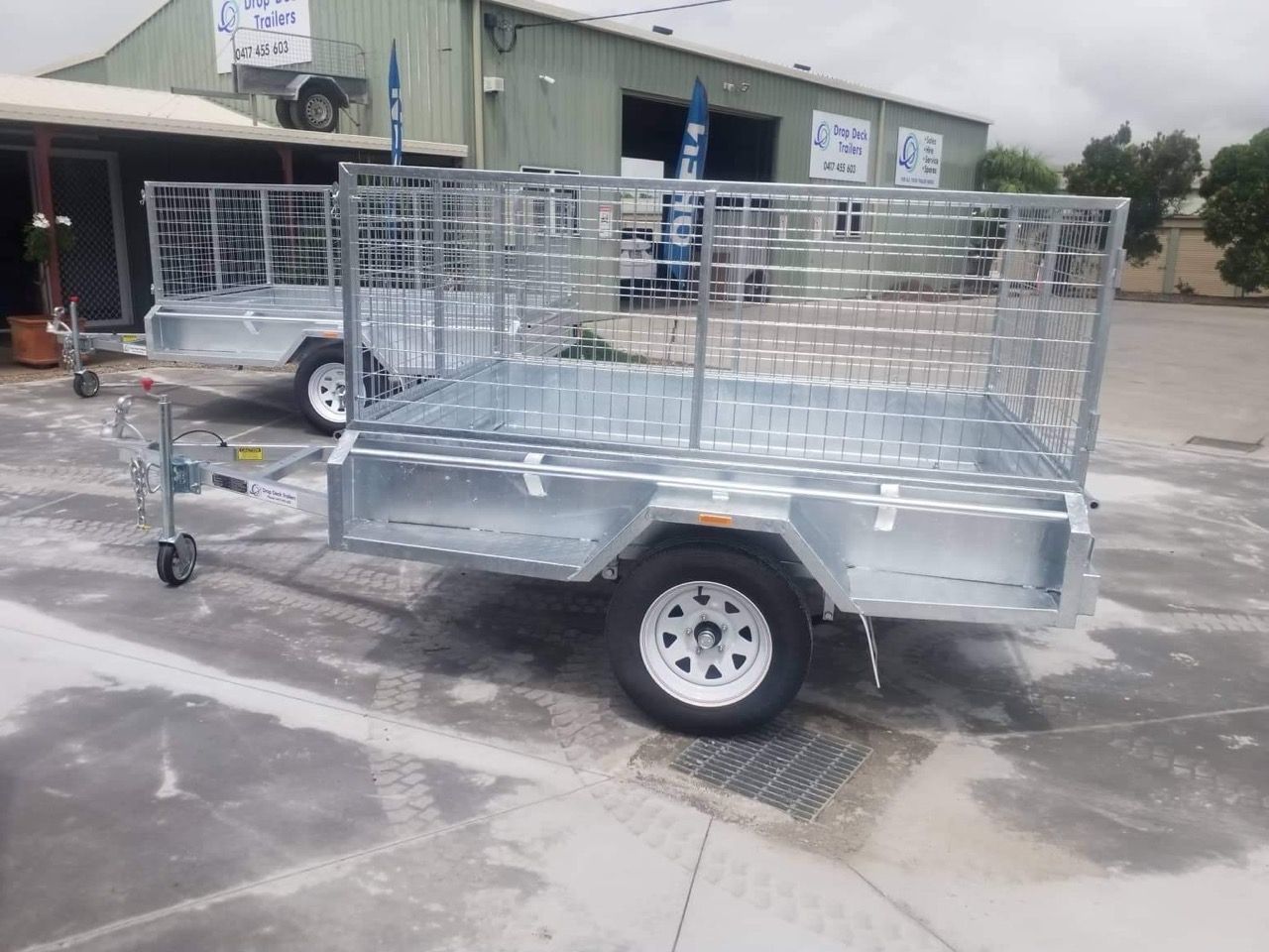 A Trailer is Parked in a Parking Lot in Front of a Building — Drop Deck Trailers In Urangan QLD