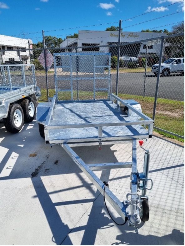 A Trailer is Parked in a Parking Lot Next to a Chain Link Fence — Drop Deck Trailers In Urangan QLD