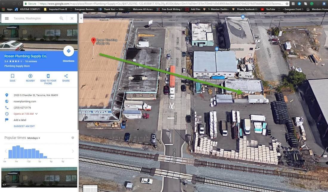 An aerial view of a building with a green arrow pointing to it.