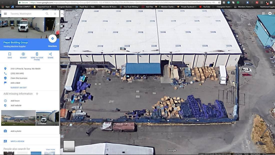 An aerial view of a large building with a google maps app open.