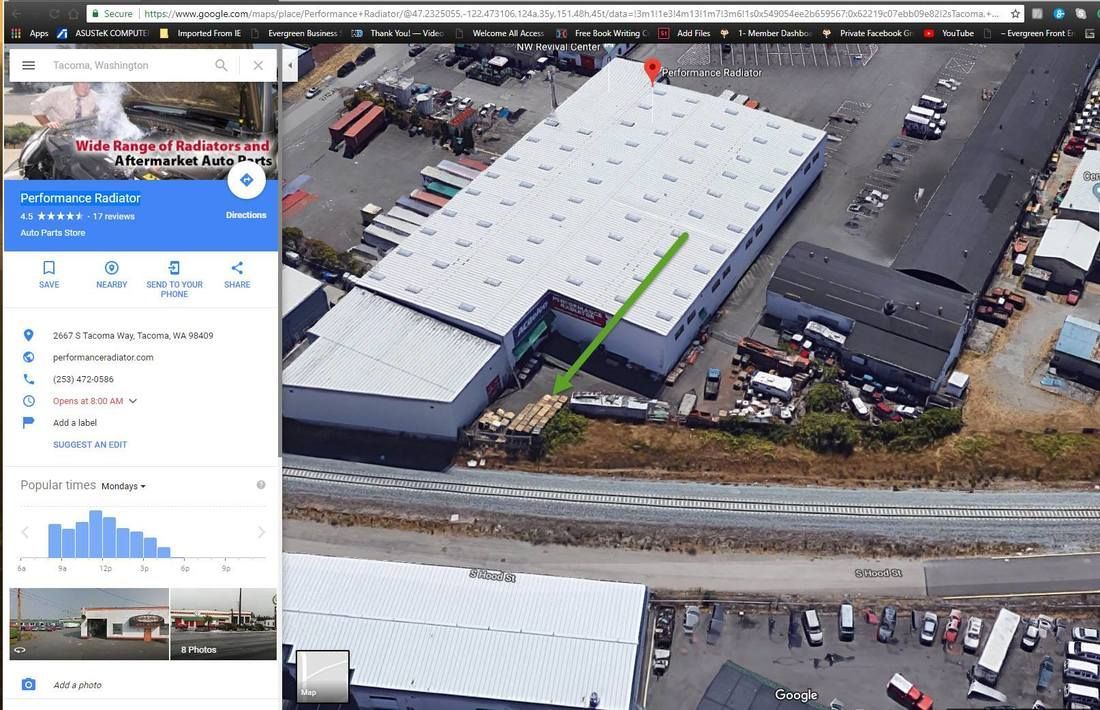 An aerial view of a large building with a green line pointing to it