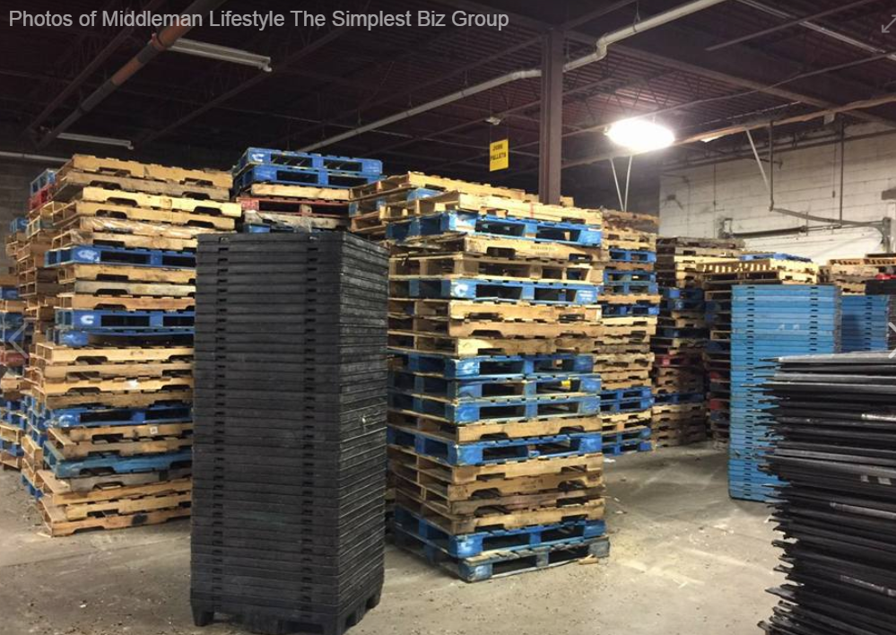 Discover pallet recycling success with The Simplest Biz Training—warehouse filled with wooden and plastic pallets