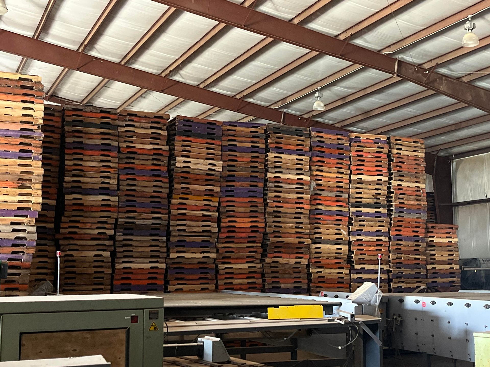 A warehouse filled with lots of wooden pallets