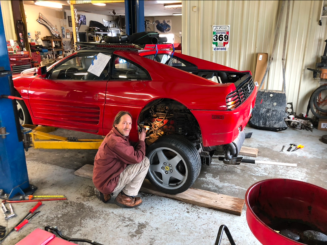 Disassembled gears and bearings, possibly from a transmission, in a workshop setting.