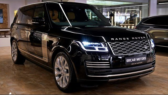 Black Range Rover SUV parked indoors.