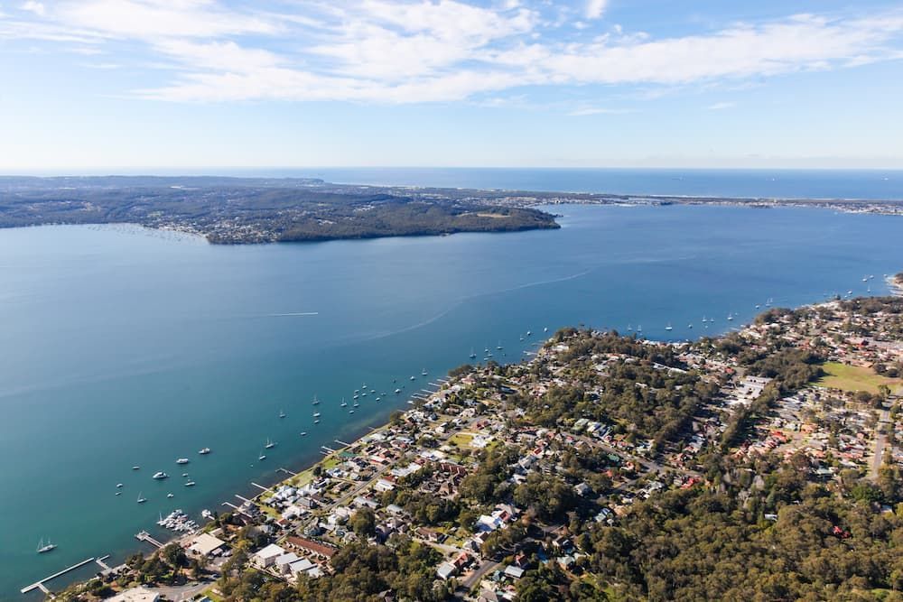An Aerial View of a Large Body of Water With a Small Island — Roof Restoration Masters In Toronto, NSW