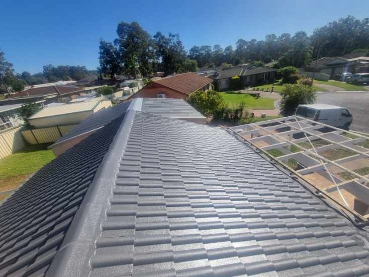 A Roof With a Lot of Tiles on It in a Residential Area — Roof Restoration Masters In Morisset Park, NSW