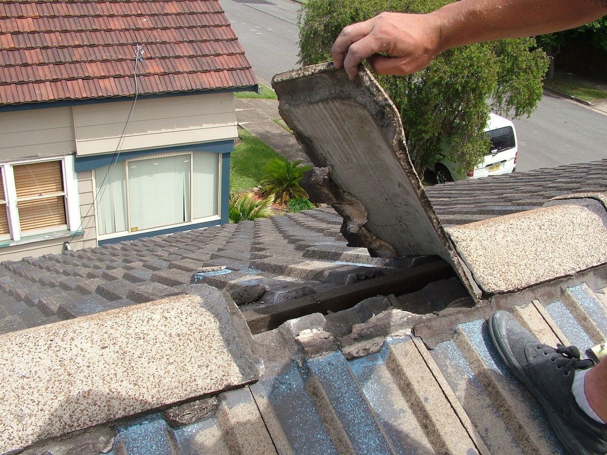 A Man Working on the Roof of a House — Roof Restoration Masters In Morisset Park, NSW