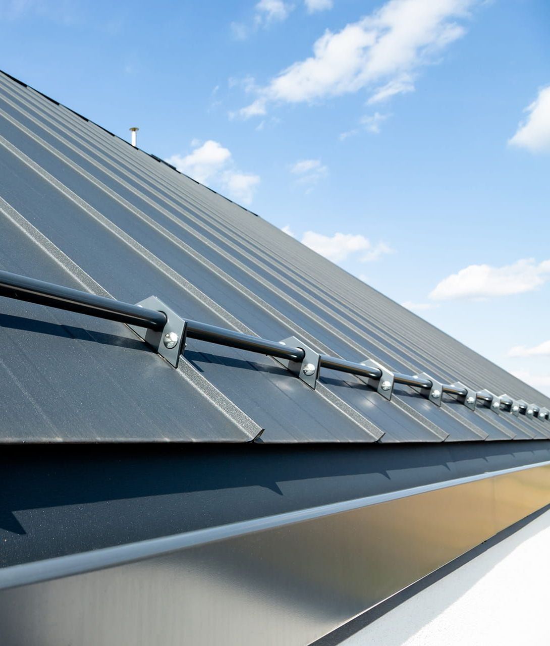 A Close Up of a Roof With Snow Guards on It — Roof Restoration Masters In Cardiff, NSW