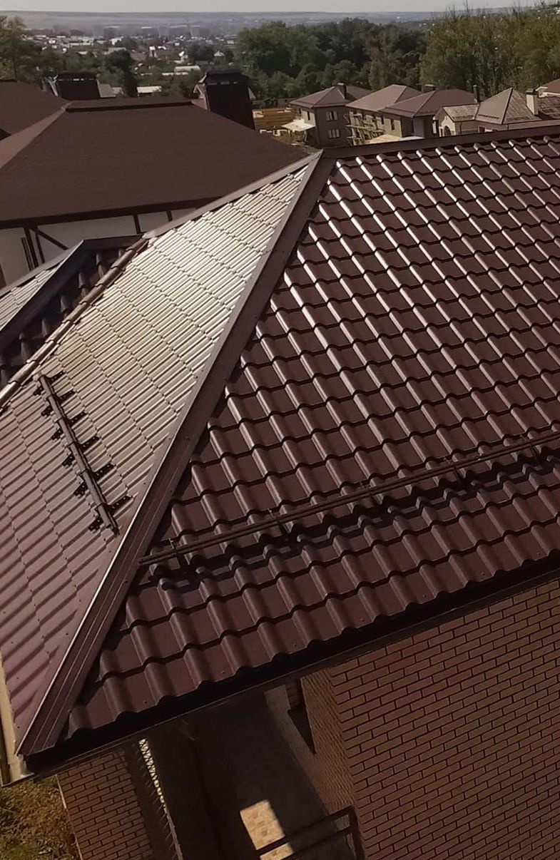 An Aerial View of a House With a Brown Tiled Roof — Roof Restoration Masters In Tuggerah, NSW