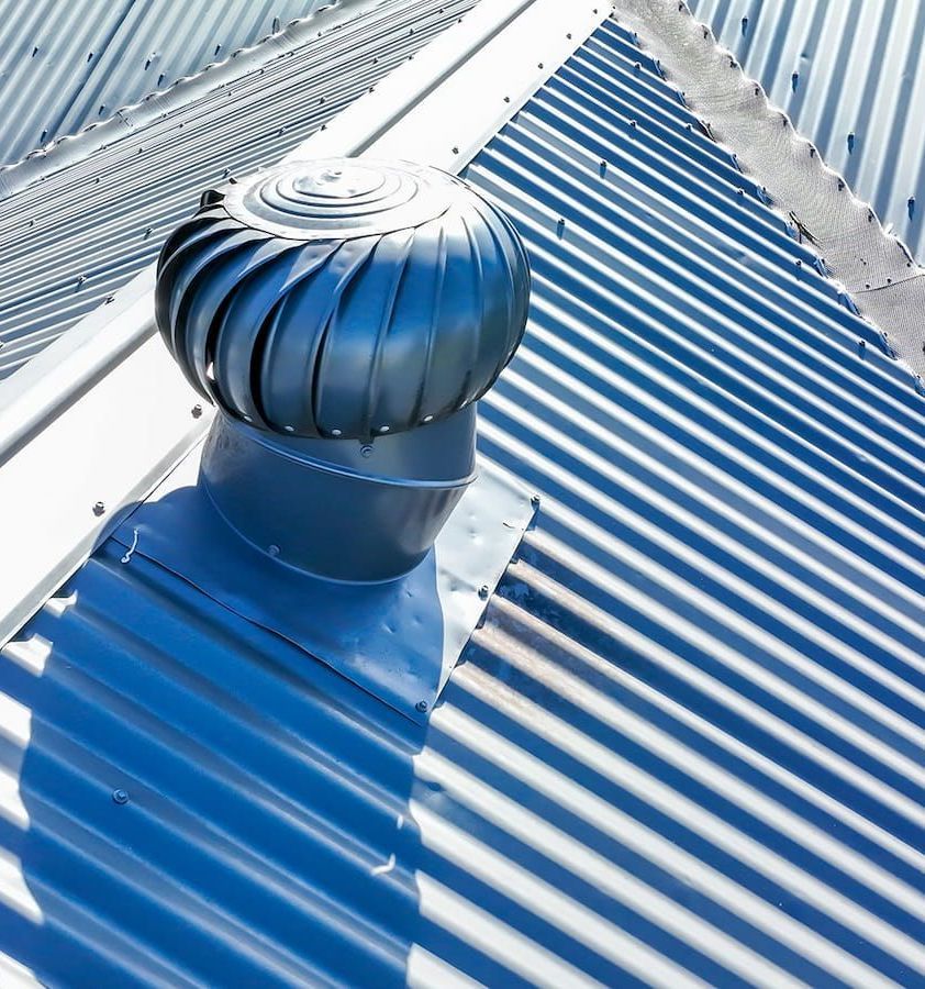 A Blue Roof With a Wind Turbine on Top of It — Roof Restoration Masters In Charlestown, NSW