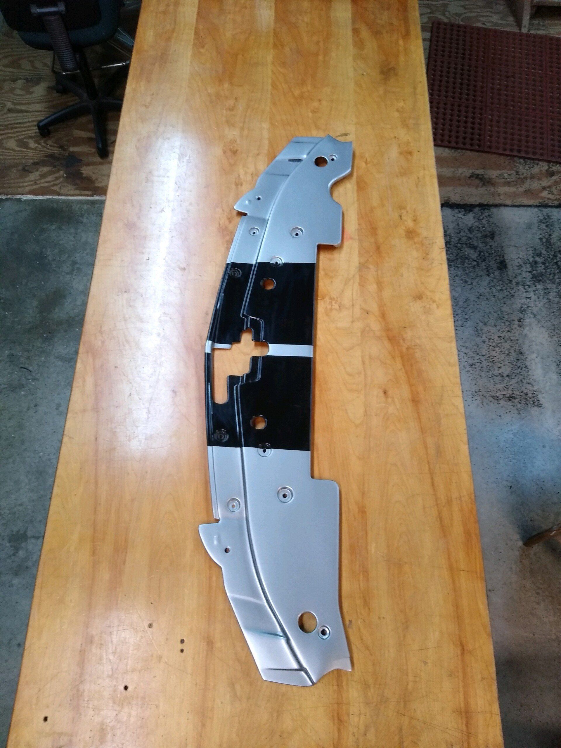 A piece of metal is sitting on a wooden table