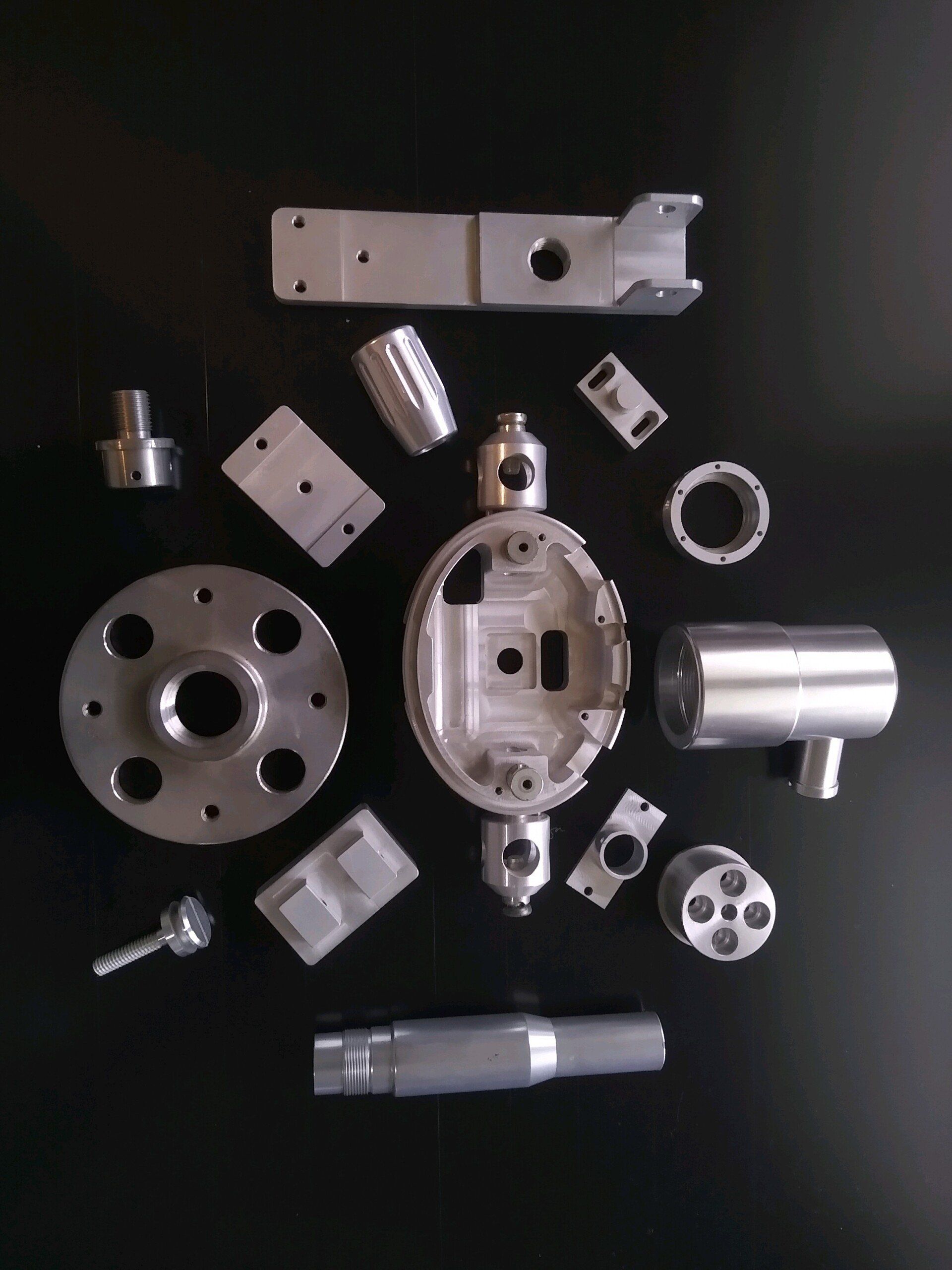 A bunch of metal parts on a black surface