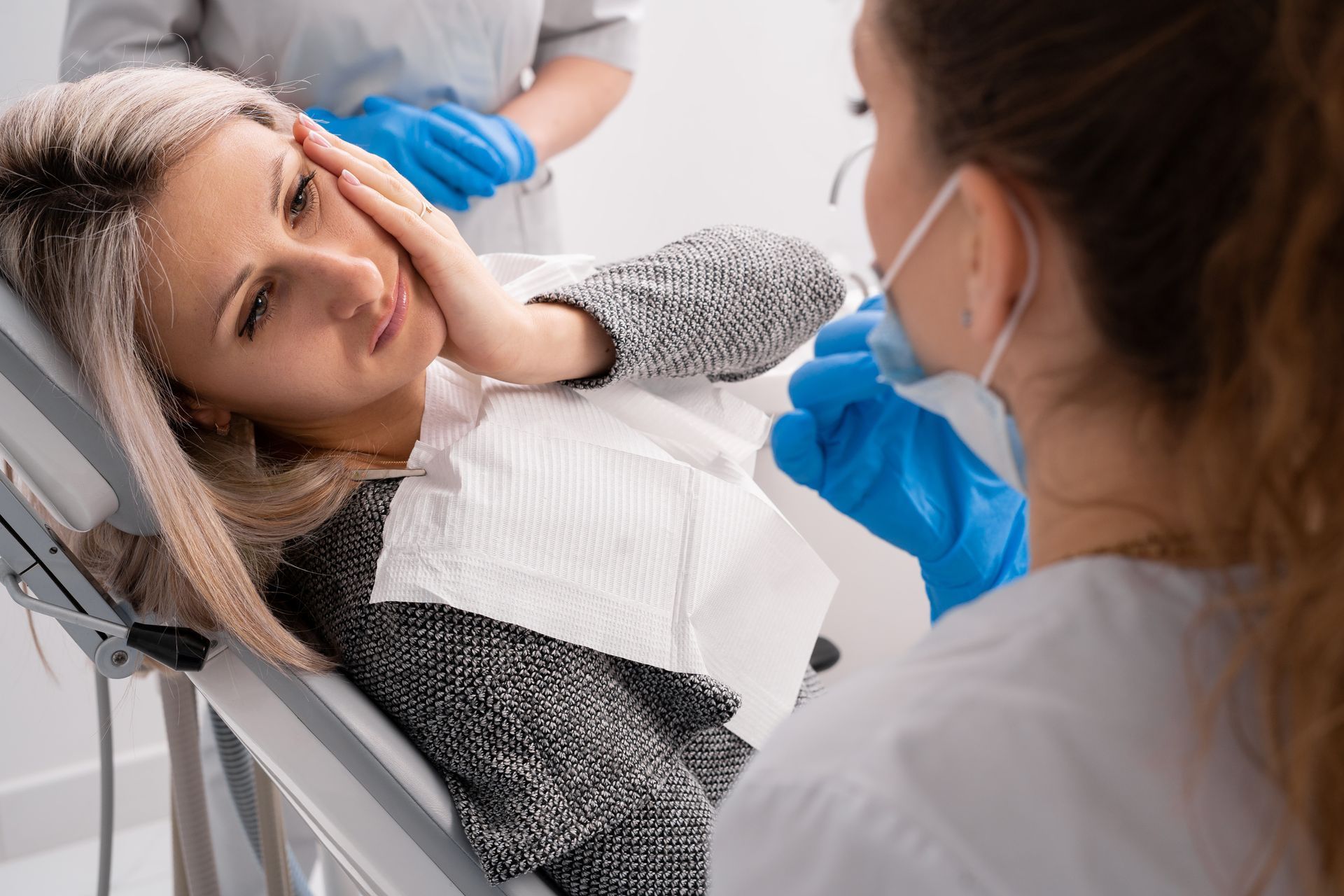 A woman is at a dental clinic due to a toothache. A woman is at a dental clinic due to a toothache.