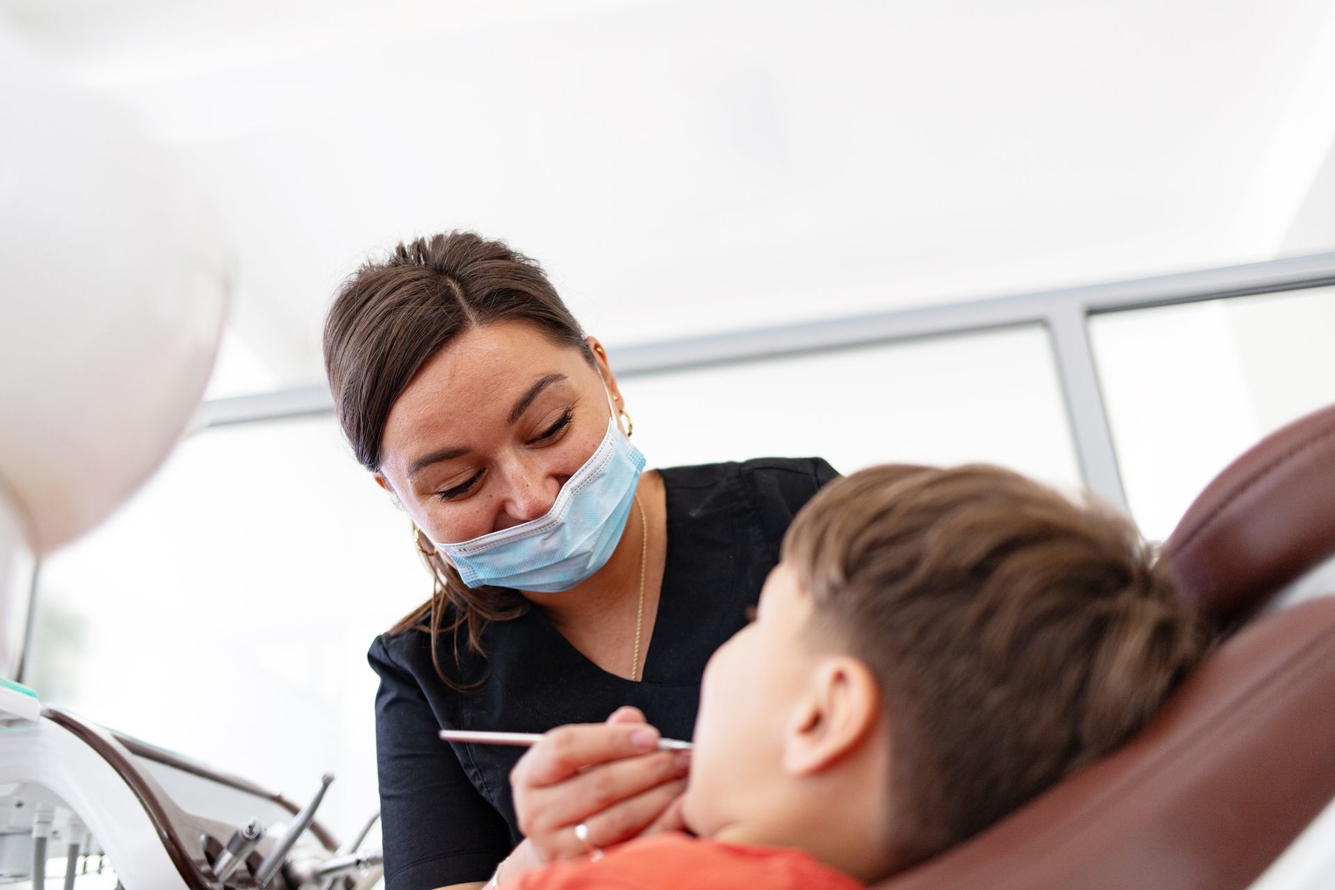 A dentist is examining a child’s teeth. A dentist is examining a child’s teeth.
