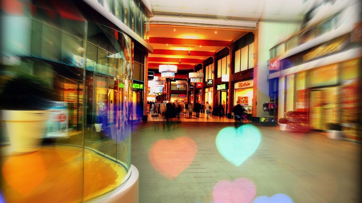 a blurry picture of a shopping mall with hearts in the background .