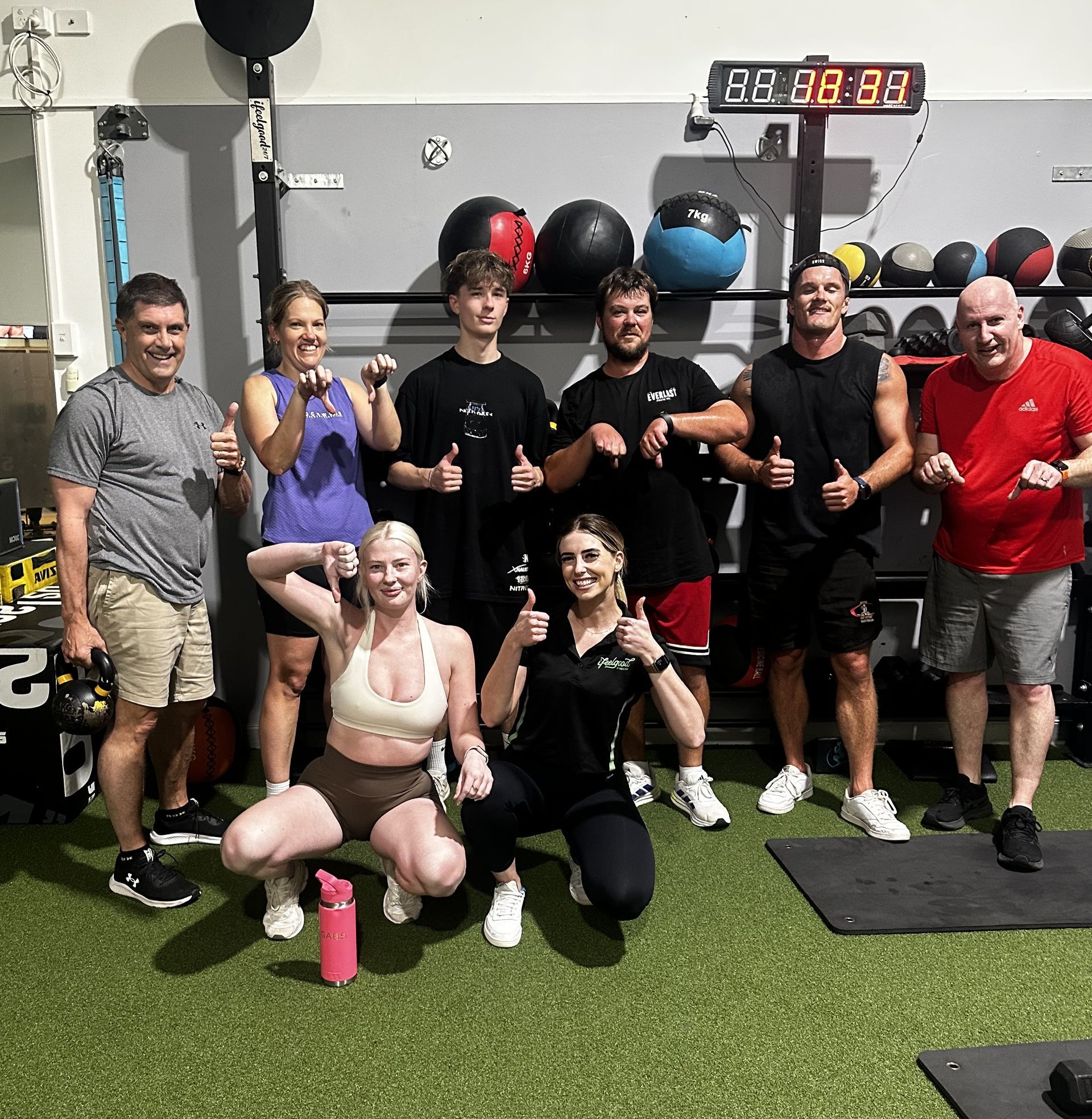 Group of people posing after a gym workout — ifeelgood 24/7 Oxenford In Oxenford, QLD