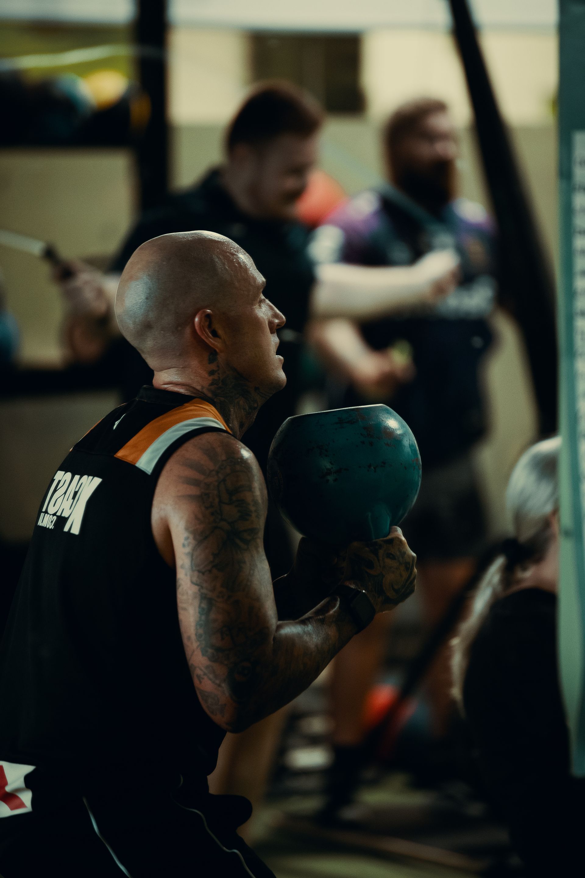 Man Squatting and Holding Dumbbell Upside Down — ifeelgood 24/7 Oxenford In Oxenford, QLD