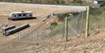 A Trailer Is Parked on The Side of A Dirt Road — Nuevo, CA — Golden West Fence