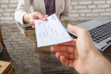 Payroll Services — Business Woman Giving Cheque in Laredo, TX