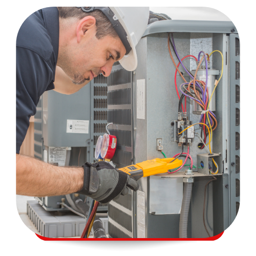 HVAC technician in a hard hat using a multimeter on an outdoor unit. Wires, gauges, and a gray setting are visible.