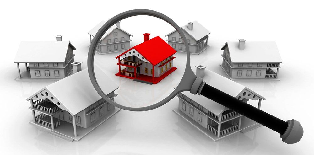 A graphic of a magnifying glass inspecting a red house.