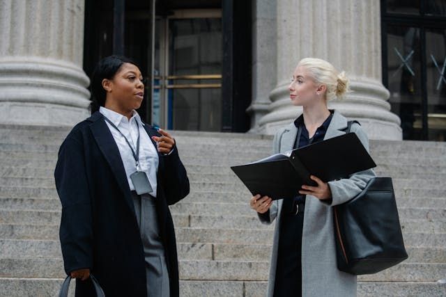 People talking outside of a courthouse