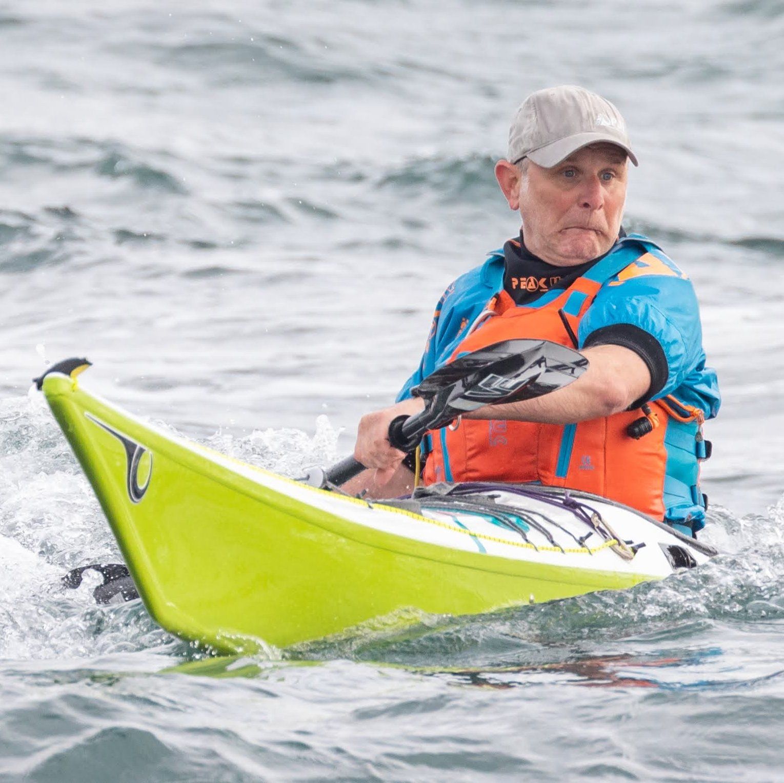 Photo of Sid Sinfield pulling a funny face in yellow sea kayak