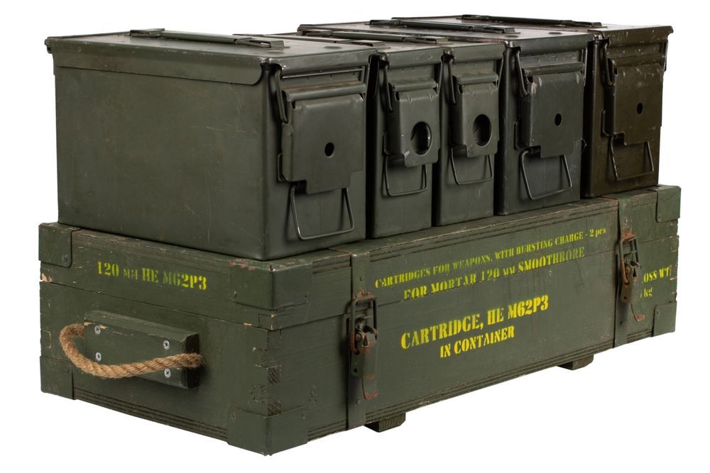 Green military ammo boxes stacked on top of a wooden crate with rope handle.