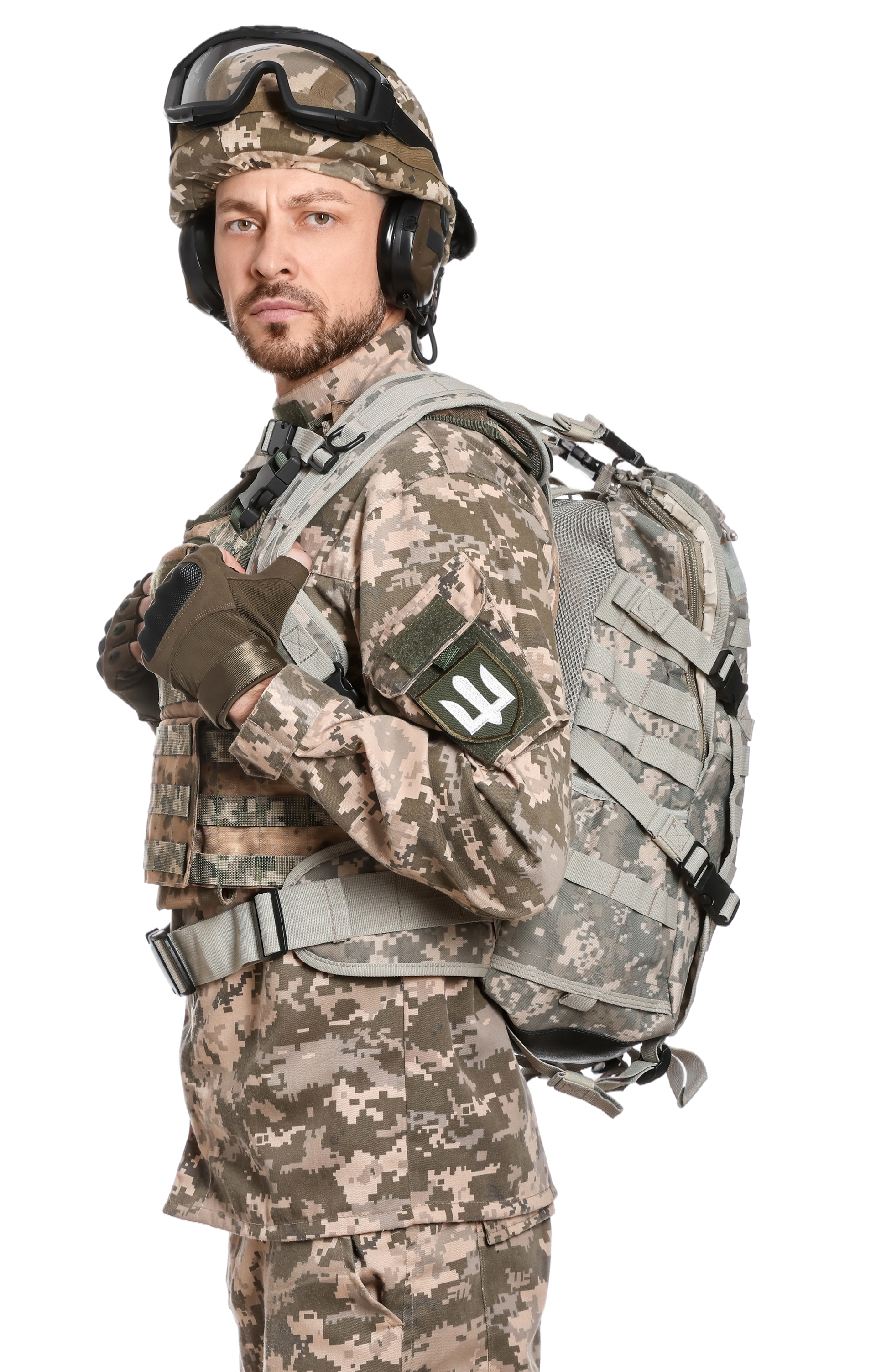 Soldier in camouflage, wearing helmet and backpack, looking at the viewer. White background.