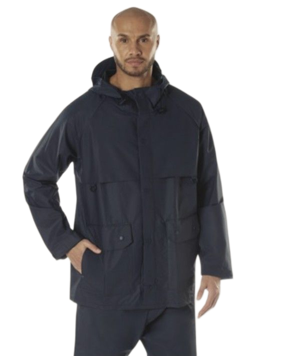 Man wearing a navy blue hooded jacket, standing with one hand in his pocket.