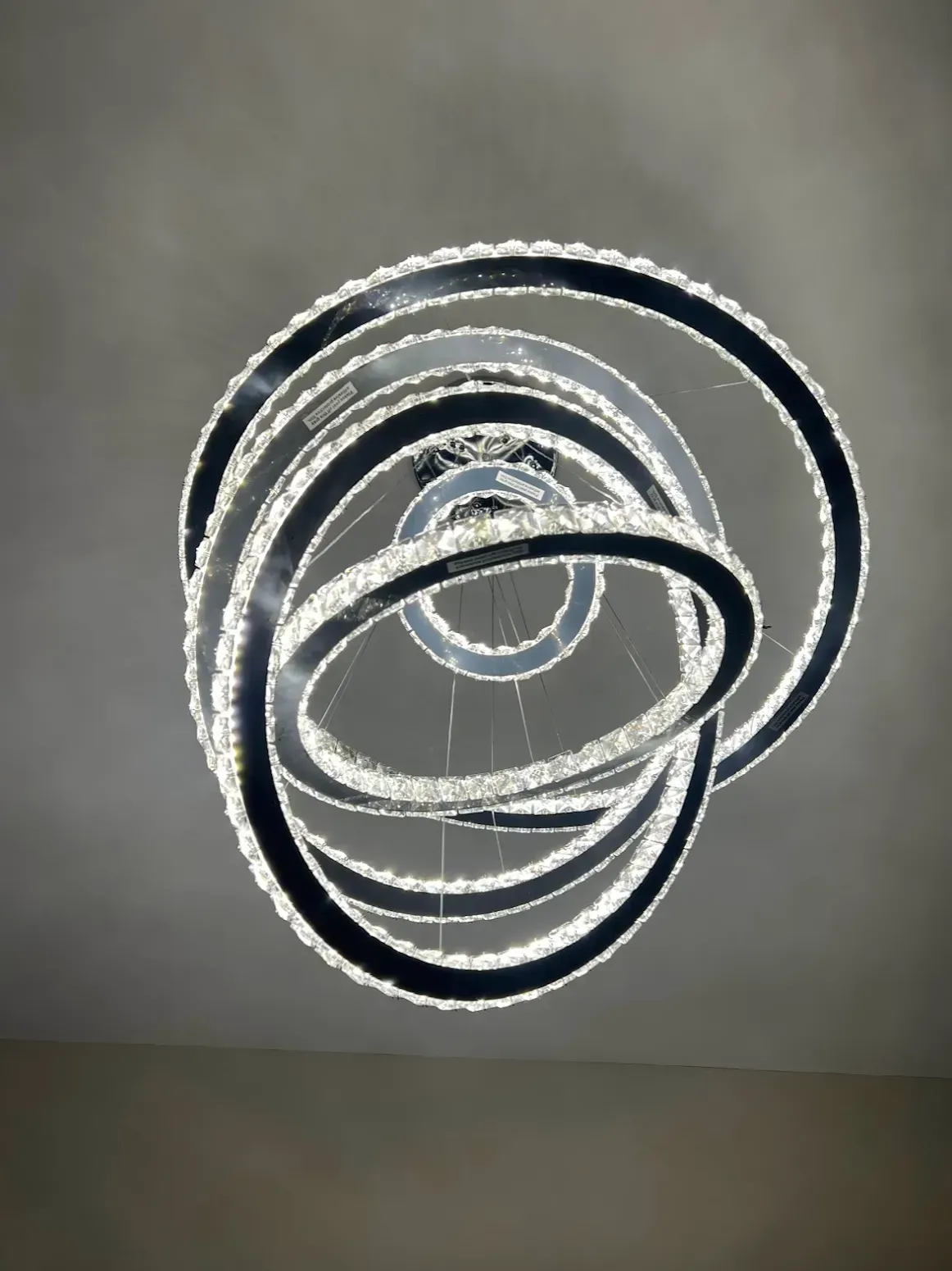 Modern chandelier with multiple circular light fixtures.