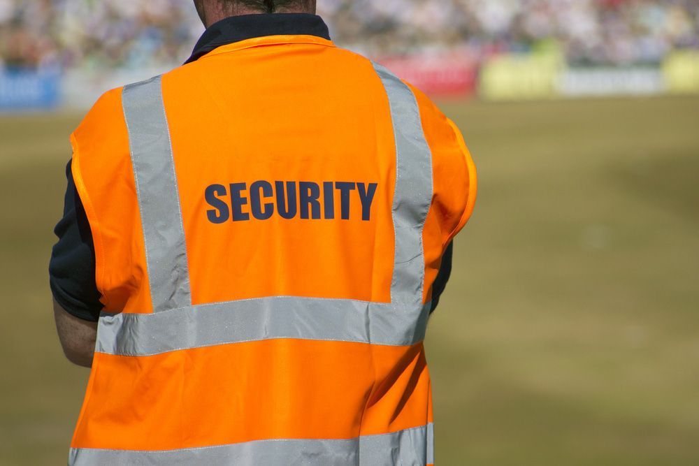 Security Man Wearing An Orange Vest — Professional Security Guards in Chinchilla, QLD