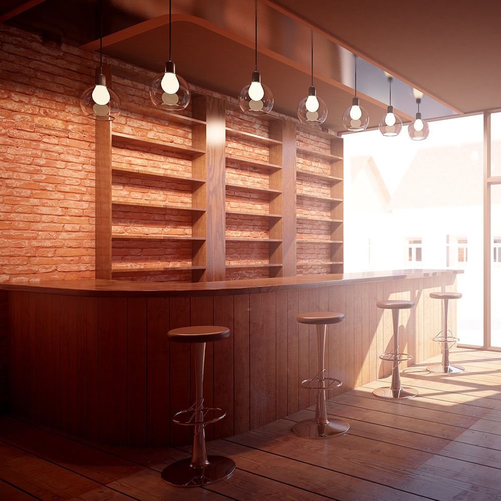 A bar with stools and a brick wall