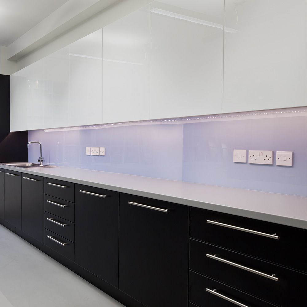 A kitchen with black cabinets and white counter tops