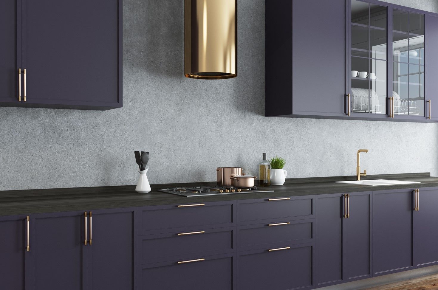 Dark blue kitchen with gold accents and light grey speckled backsplash.
