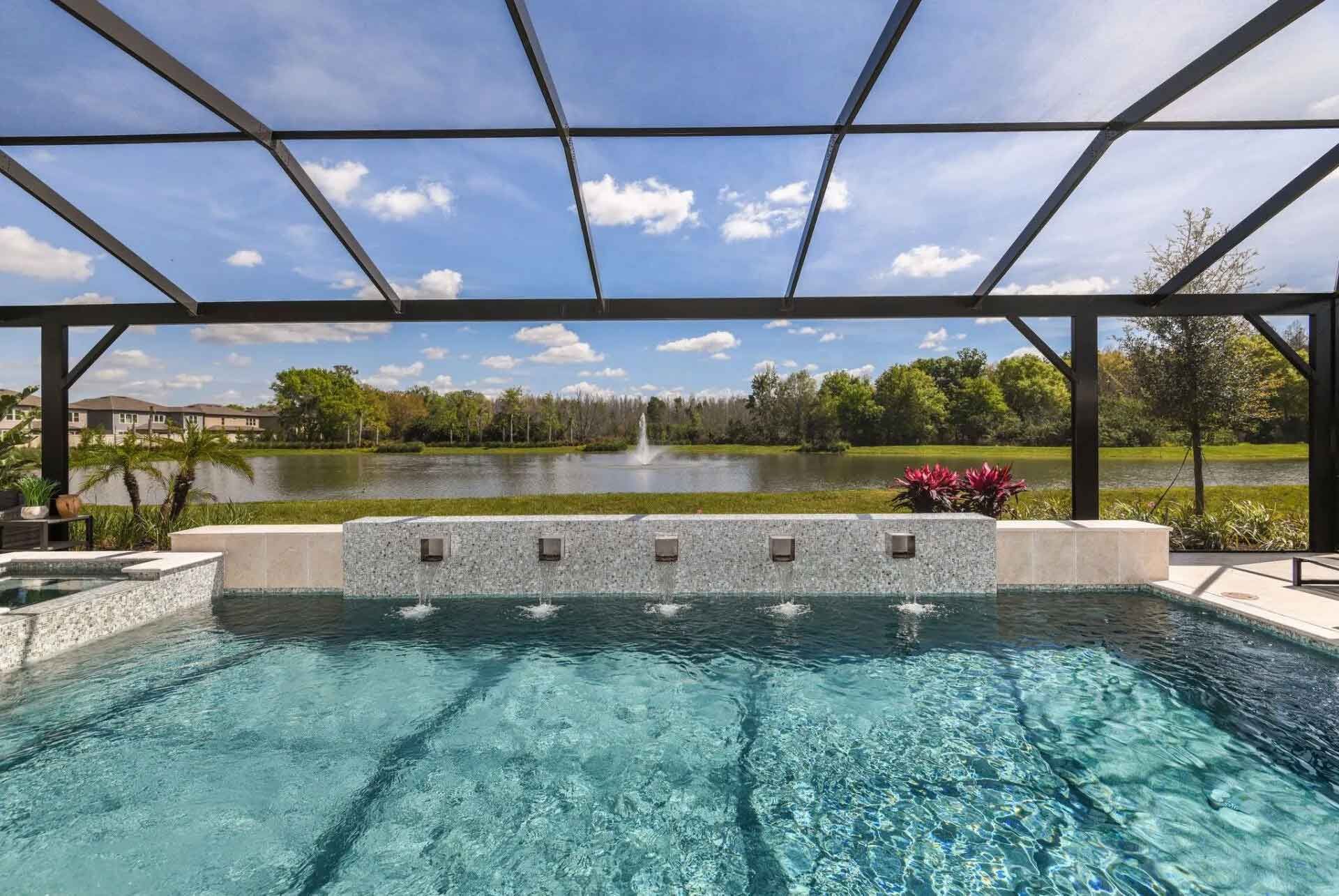A large swimming pool with a view of a lake.