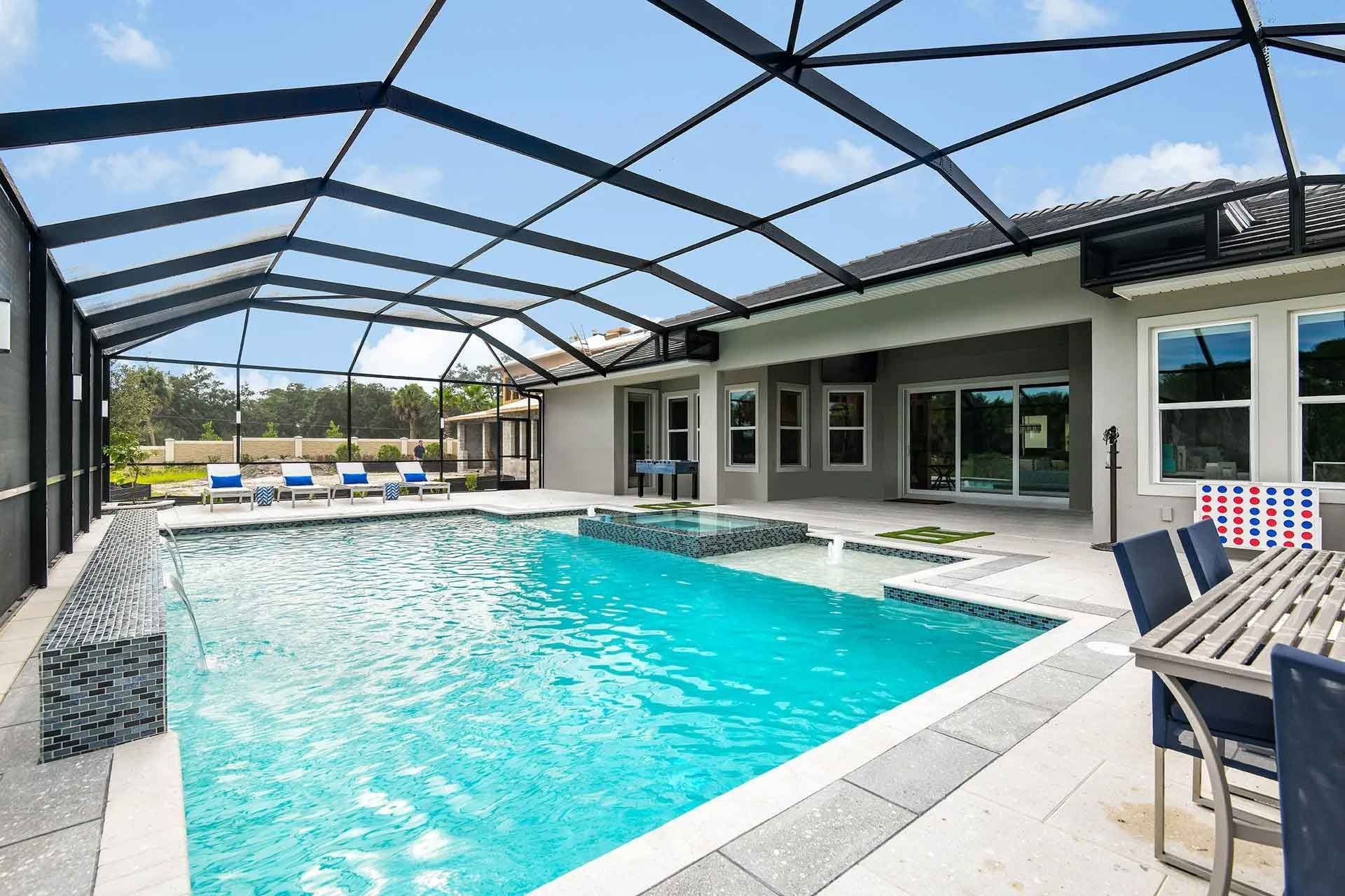 A large swimming pool in the backyard of a house