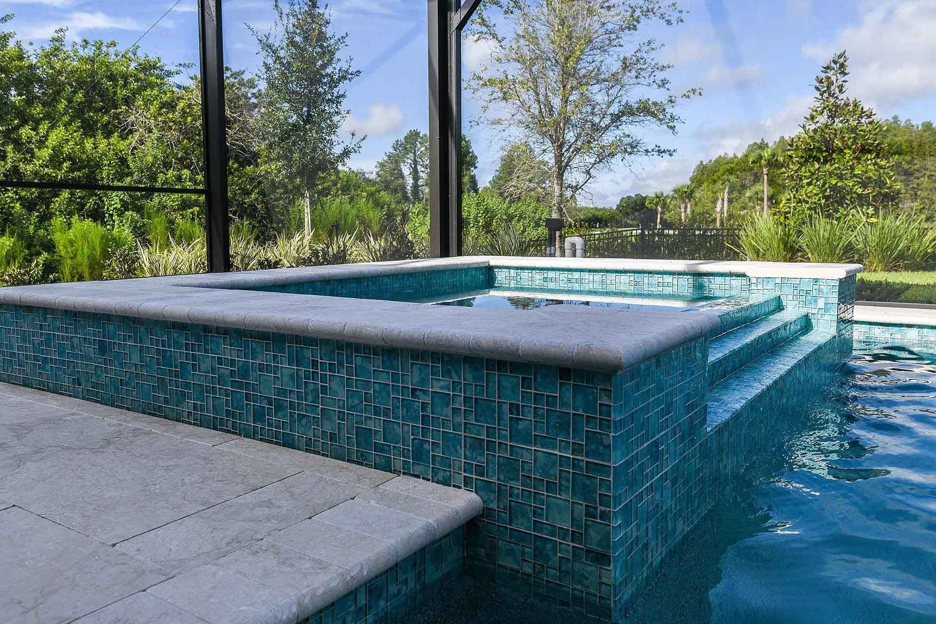 A swimming pool with a hot tub in the middle of it