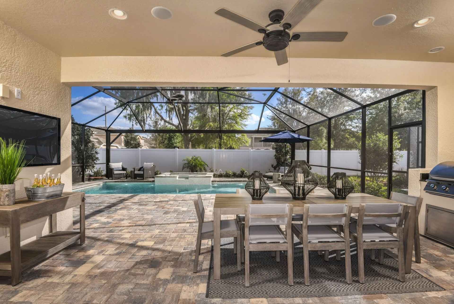 A patio with a table and chairs and a ceiling fan