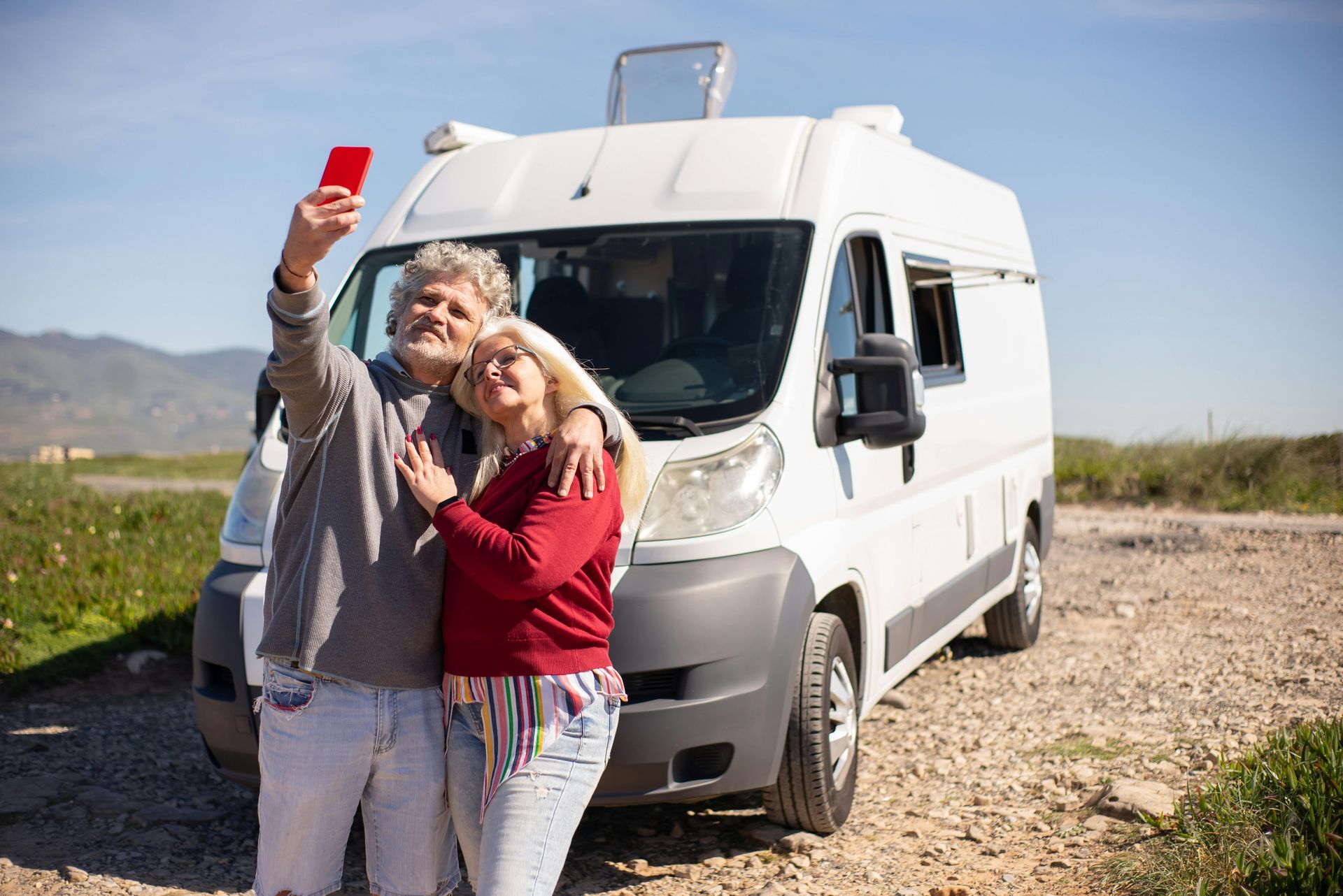 A happy couple next to an RV