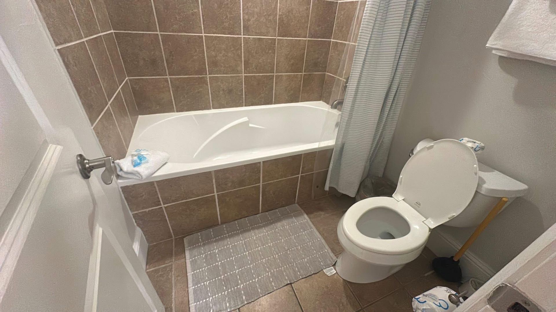 Tiled floor before and after cleaning. Soap and brush used on right side, removing dirt and grime from grout.