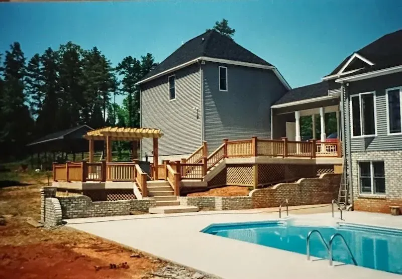 A large house with a swimming pool in front of it