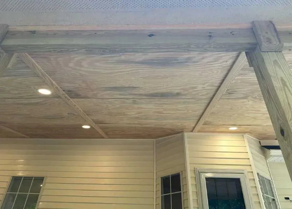 A room with a wooden ceiling and a window.