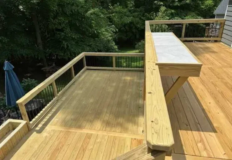 A wooden deck with stairs and a table on it.